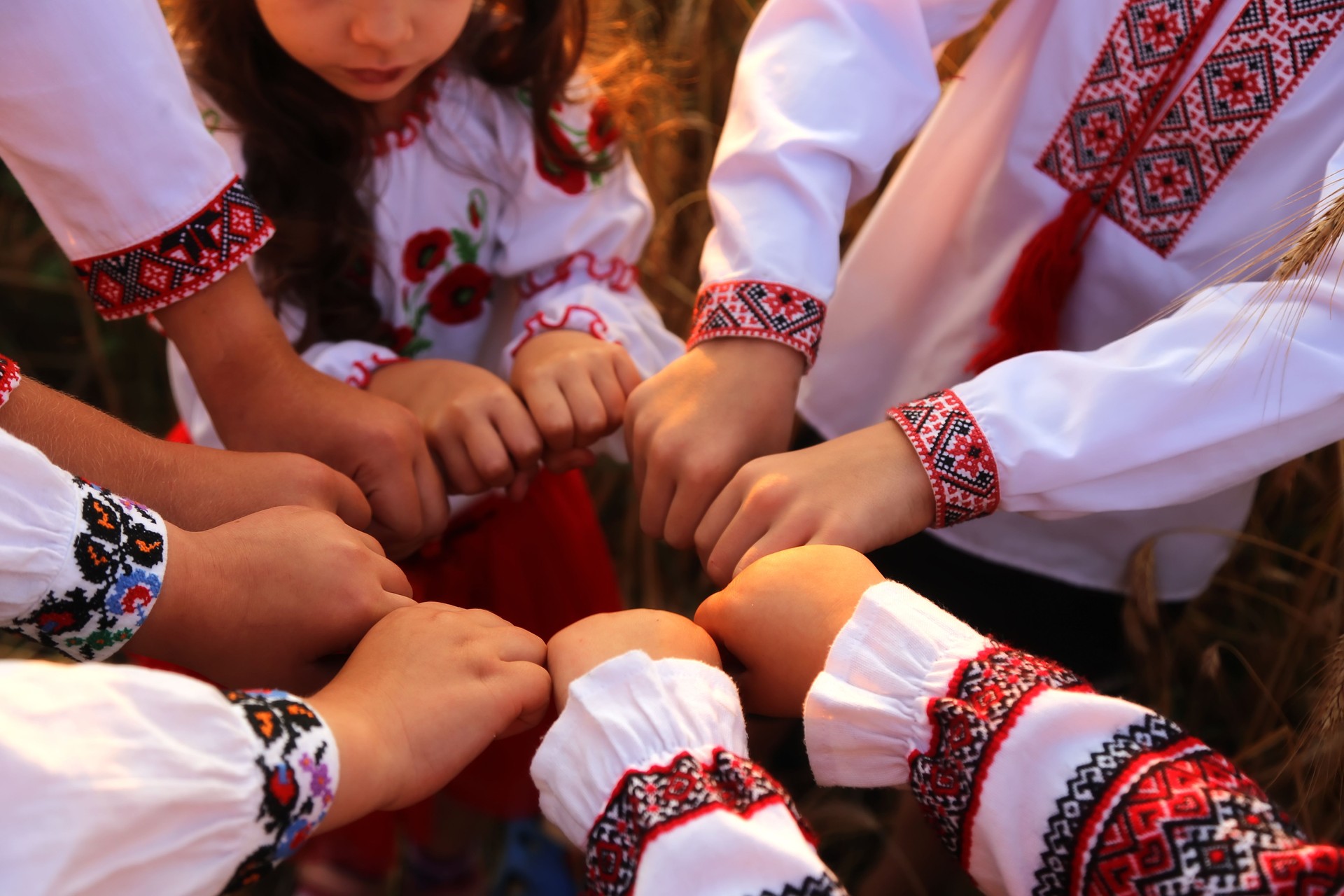 The hands of children in embroidered shirts are joined in a welcoming gesture. The united hands form a cykle symbolize unity. Independence Day of Ukraine, Constitution, Embroidery